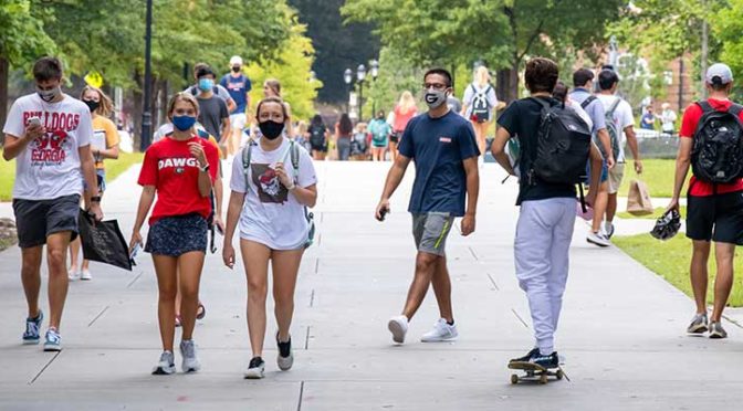 College students on campus walking around with masks on